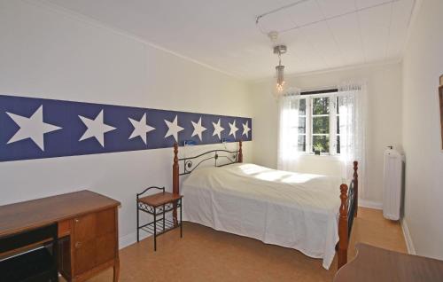 a bedroom with a bed with stars on the wall at Stunning Home In Älgarås With Wifi in Älgarås