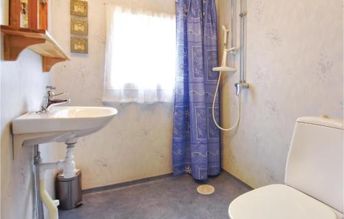 a bathroom with a sink and a toilet and a window at Beautiful Home In Klssbol With 2 Bedrooms And Wifi in Prästhög