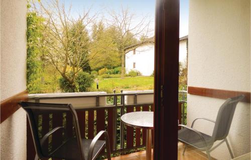 a patio with a table and chairs on a balcony at Ferienhaus 22 In Thalfang in Thalfang