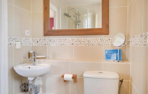 a bathroom with a sink and a toilet and a mirror at Awesome Home In Puy Levque With Private Swimming Pool, Can Be Inside Or Outside in Puy-lʼÉvêque