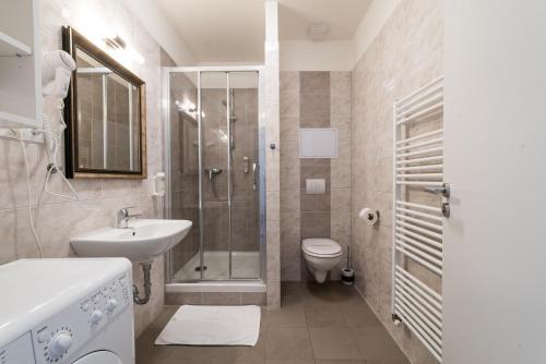 a bathroom with a shower and a sink and a toilet at MyApartment in the city center in České Budějovice