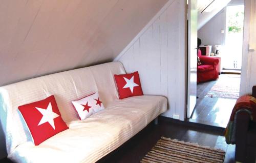 a white couch with red and white pillows on it at Nice Home In Vanse With House Sea View in Vanse