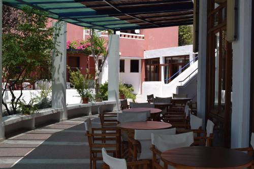 a row of tables and chairs on a patio at Porto Galini in Agia Galini