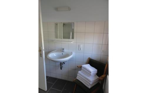 a bathroom with a sink and a pile of towels at Amazing Apartment In Waabs With 1 Bedrooms And Wifi in Waabs