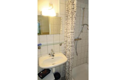 a bathroom with a sink and a mirror at 3 Bedroom Cozy Apartment In Paesens in Paesens