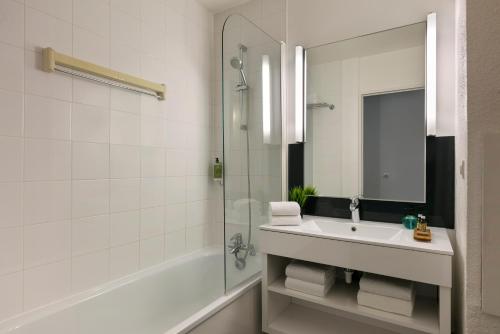 a bathroom with a sink and a shower at Citadines Austerlitz Paris in Paris