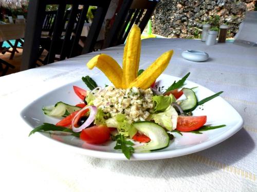 a plate of food with vegetables on a table at Las Puertas del Paraíso in Río San Juan