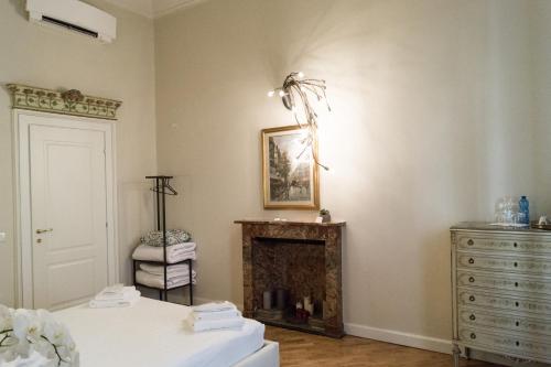 a bedroom with a dresser and a fire place at Ilsanleonardo in Bergamo