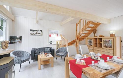 a living room with a table and chairs and a staircase at 2 Bedroom Lovely Home In Zerpenschleuse in Zerpenschleuse