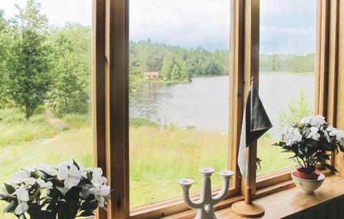 a window with a view of a lake at Holiday Home Spångens Motorbåtsklubb Åsensbruk in Åsensbruk