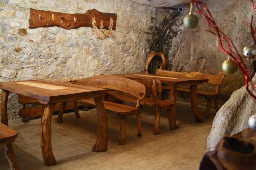 a dining room with wooden tables and chairs at Galabova Guesthouse in Delchevo