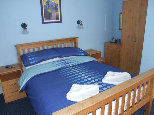 Braedene Lodge tesisinde bir odada yatak veya yataklar