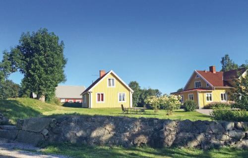 a yellow house with a bench in front of it at Holiday Home Holmsjövägen Holmsjö Ii in Holmsjö