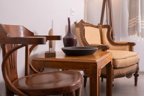 a wooden table with chairs and a bowl on it at LUWİ ANTAKYA BOUTİQUE HOTEL in Hatay