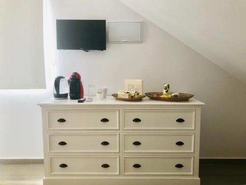 a dresser with a tv on top of it at Hostal El Caprichito Marbella in Marbella