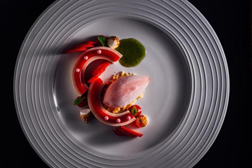 a white plate with a piece of food on it at Hotel-Restaurant Bellevue in Flims