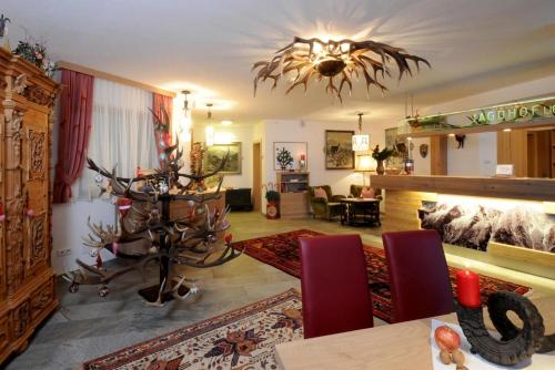a living room with a chandelier hanging from a ceiling at Jagdhof Ligedl in Mayrhofen