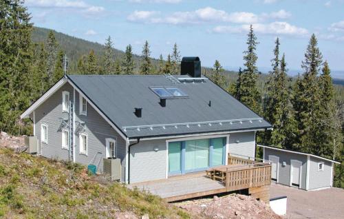 a house on top of a hill with trees at Beautiful Home In Sörsjön With Sauna in Lindvallen