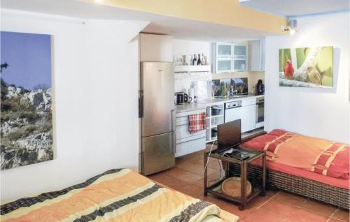 a kitchen with a bed and a desk in a room at Stunning Apartment In Linz Am Rhein in Linz am Rhein