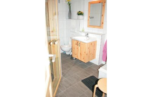 a small bathroom with a sink and a toilet at Beautiful Home In Sörsjön With Sauna in Lindvallen