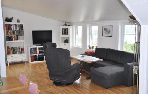 a living room with a couch and a table at Cozy Apartment In Fitjar in Fitjar