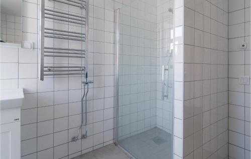 a bathroom with a shower with white tiled walls at Awesome Apartment In Visby With 3 Bedrooms And Wifi in Visby