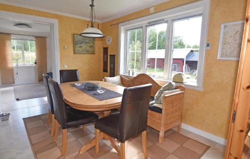 a dining room with a wooden table and chairs at 4 Bedroom Nice Home In Årjäng in Årjäng