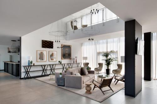 a living room with a couch and a table at J Hotel in Turin