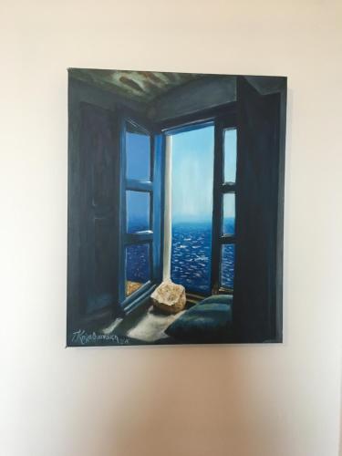 a painting of a window with a view of the ocean at Alonia Studios in Firostefani