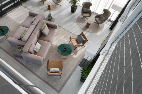 an overhead view of a living room with a couch and chairs at J Hotel in Turin