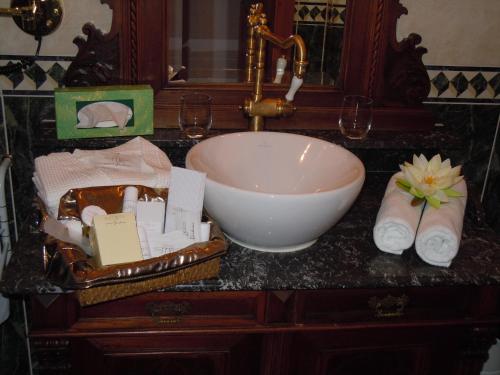a bathroom counter with a bowl sink and towels at Boutique Hotel Ur-Wachau in Weissenkirchen in der Wachau