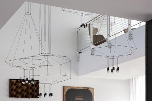 a room with glass chandeliers hanging from the ceiling at J Hotel in Turin