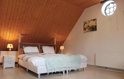a bedroom with a large bed with a wooden ceiling at Cozy Home In De Meern With Wifi in Utrecht