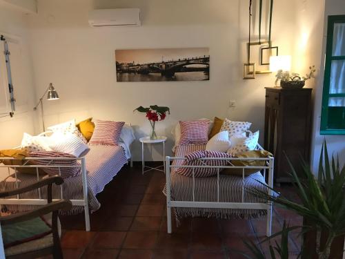 a room with two beds and a bridge on the wall at Apartamento Suite Las Setas in Seville