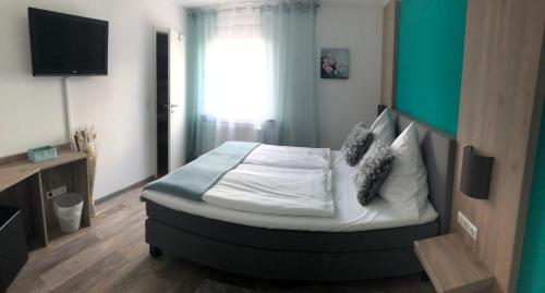 a bedroom with a bed and a television in it at Casalino in Wachtendonk