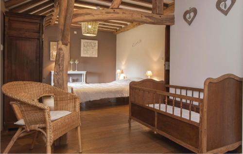 a bedroom with a bed and a crib at Hourlay in Morville