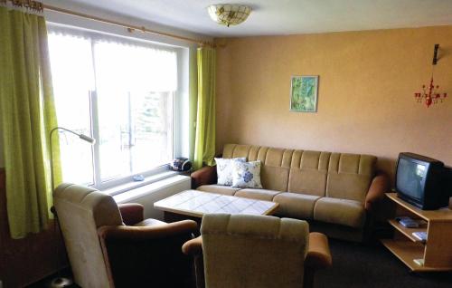 a living room with a couch and a tv at Nice Home In Schwarzenberg With 2 Bedrooms in Schwarzenberg