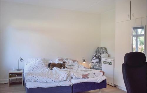 a dog laying on a bed in a bedroom at 6 Bedroom Gorgeous Home In Tomelilla in Tomelilla