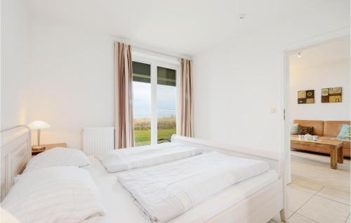 una camera bianca con due letti e una finestra di Awesome Apartment In Rechlin With Sauna a Rechlin