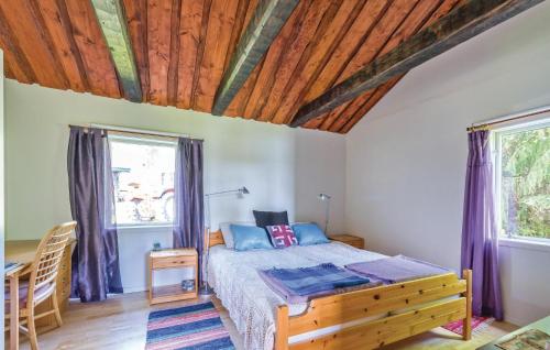 a bedroom with a bed and a wooden ceiling at Amazing Home In Lgde With 1 Bedrooms And Wifi in Himmersundet