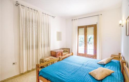 a bedroom with two beds and a window at Nice Home In Benissa With 3 Bedrooms, Wifi And Outdoor Swimming Pool in Benissa