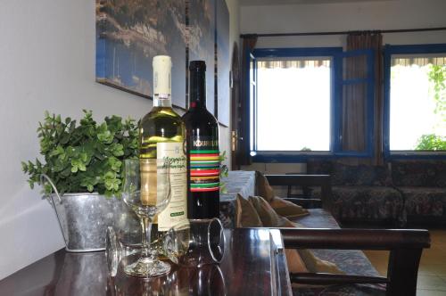 two bottles of wine sitting on top of a table at Villa Panorama in Pefkos in Pefki