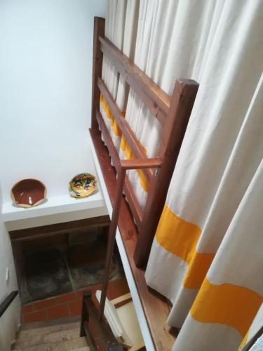 a room with a table and a shelf with a curtain at Casa do Ferreiro in Tolosa