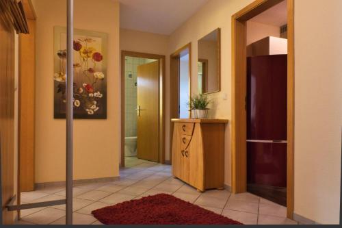 um corredor com uma casa de banho com um lavatório e um espelho em Ferienwohnung Sonnensegel em Petersdorf auf Fehmarn