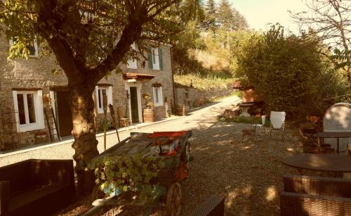 a cart parked next to a building with a tree at Villa Gioia in Acqui Terme