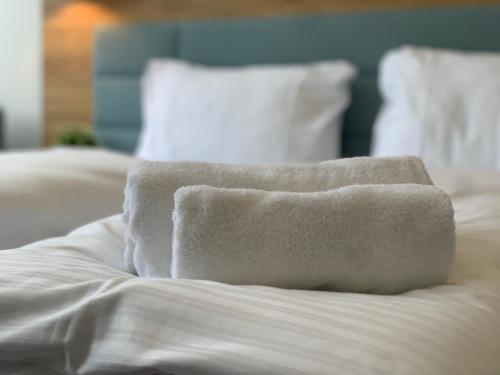 a pile of towels sitting on top of a bed at besttime Hotel Monschau in Monschau