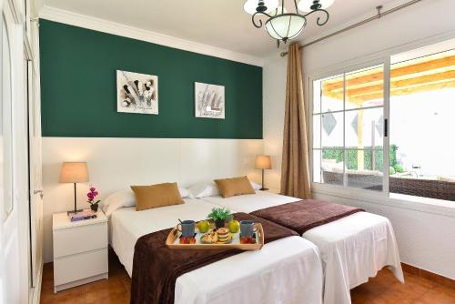 A bed or beds in a room at Jacuzzi & Garden Holiday Home