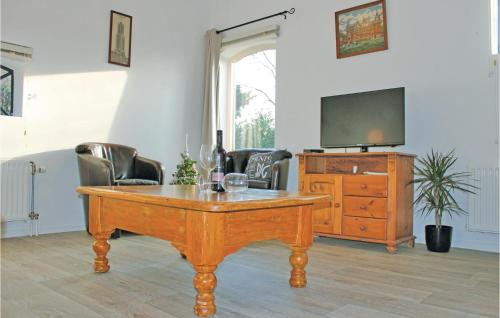 a living room with a wooden table and a television at Cozy Home In De Meern With Wifi in Utrecht
