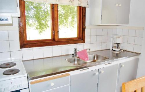 a kitchen with a sink and a window at Beautiful Home In Lidhult With Kitchen in Torarp