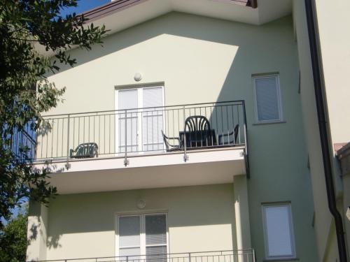 a building with two chairs on a balcony at Residence Villa Susy in Duino